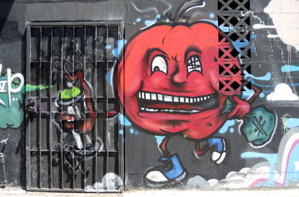 greedy red tomato guy, a large red tomato with a face, dollar signs in one eye, large blue sneakers on skinny legs, and he's holding a bag of money 