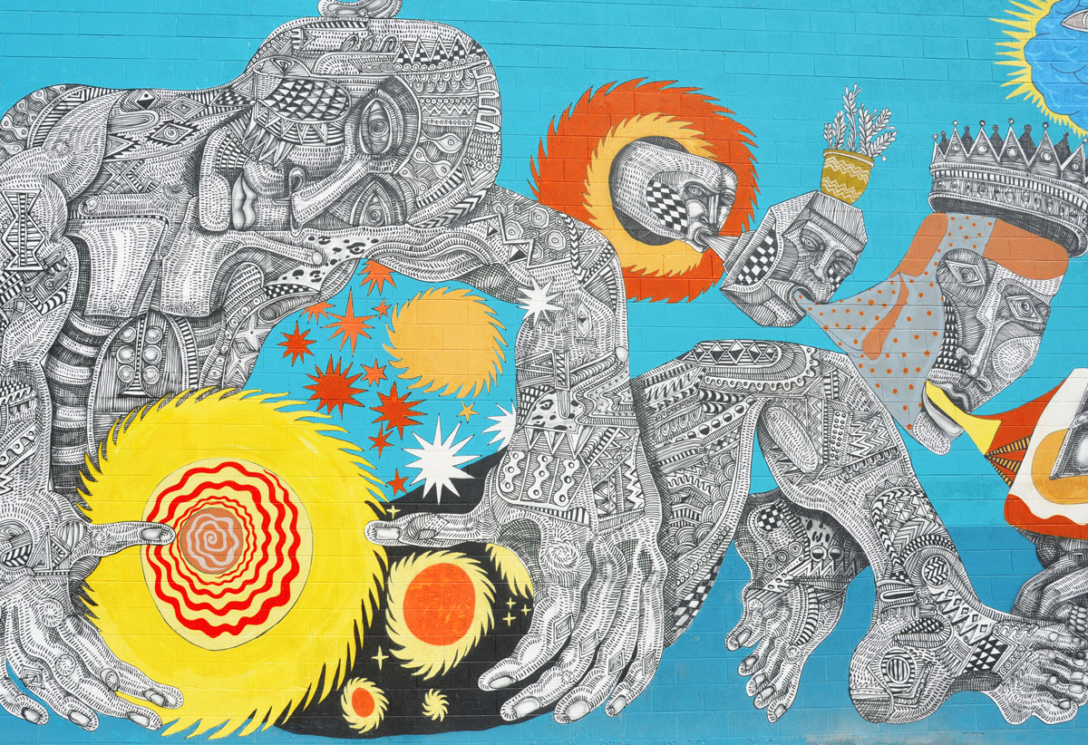 close up of part of a large mural, a man seated, round yellow objects