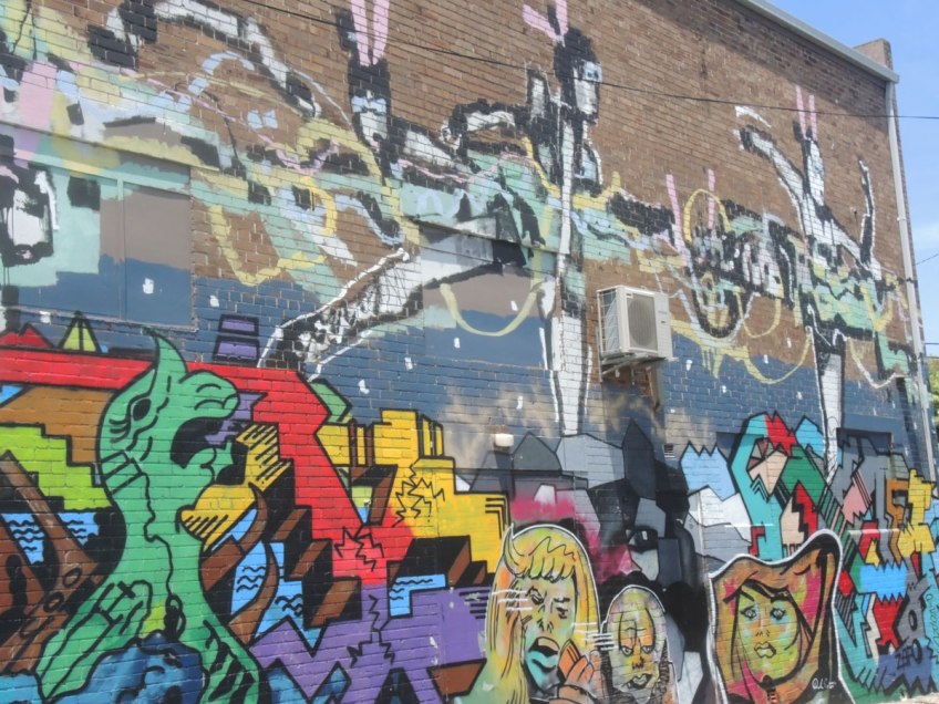 large two storey mural in a lane in Newtown Sydney