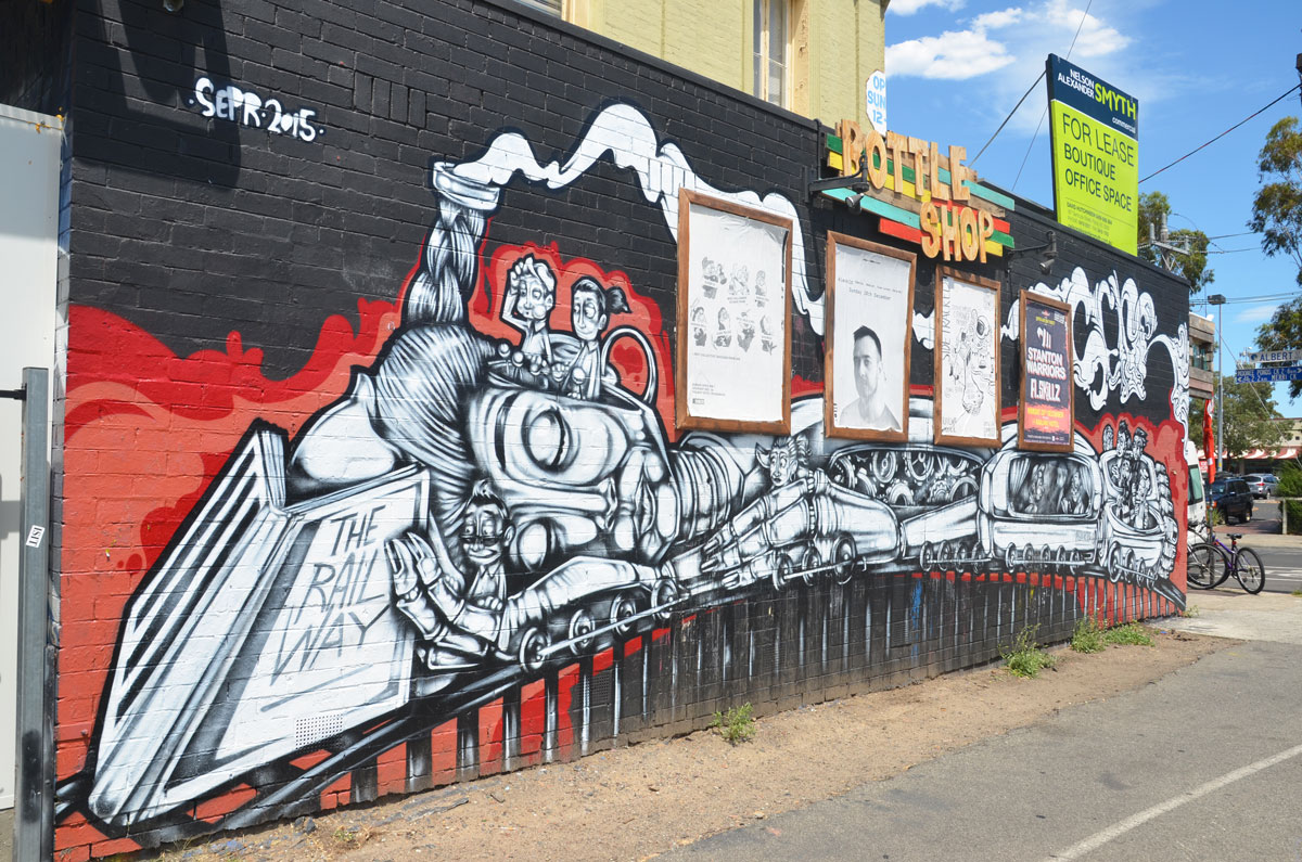 Mural of a train on a wall, along the side of the Railway Hotel