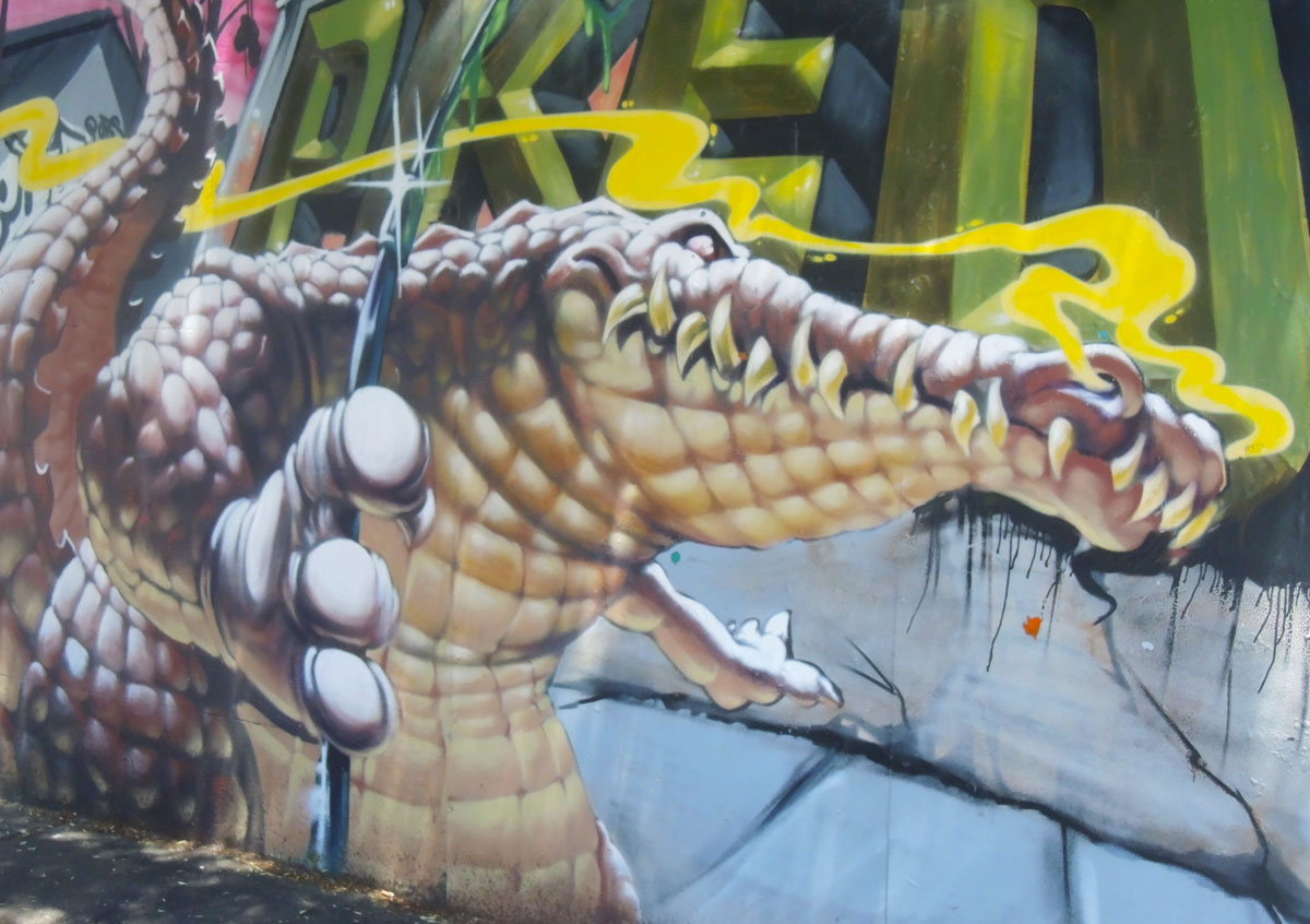 part of a larger mural, a realistic looking crocodile with lots of teeth