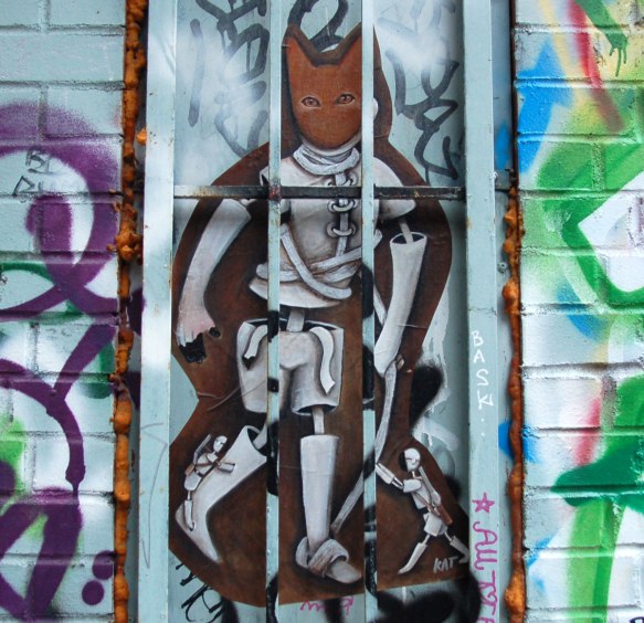 poster of anthromorphic creature with animal mask on, upright standing cat with small human creatures trying to climb up its legs