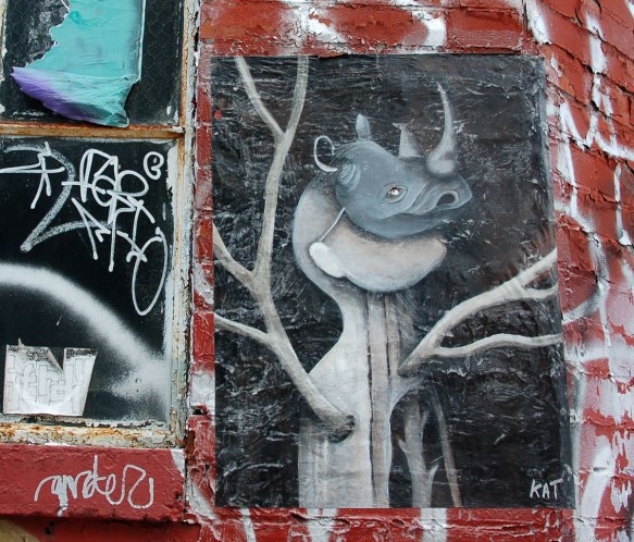 poster of anthromorphic creature with animal mask on, rhinocerous. creature has branches, or antlers, for arms