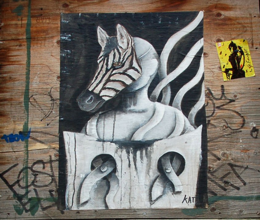 poster of anthromorphic creature with animal mask on, zebra mask, front hooves are in stocks (as in the old form of punishment) so it can't move