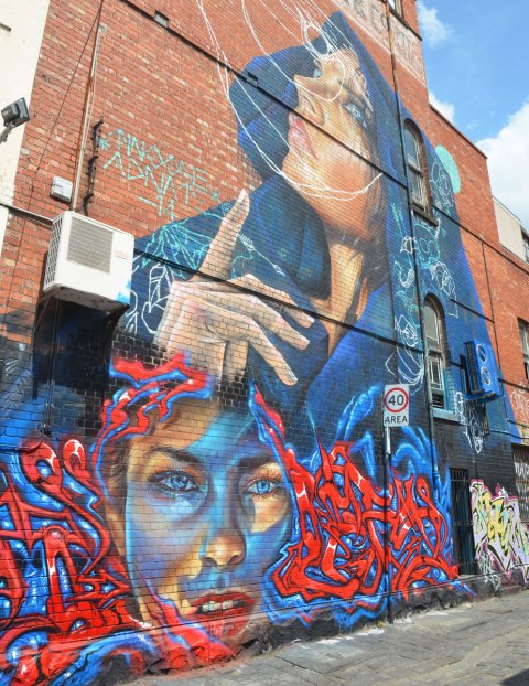 mural of two women, three stories high, 