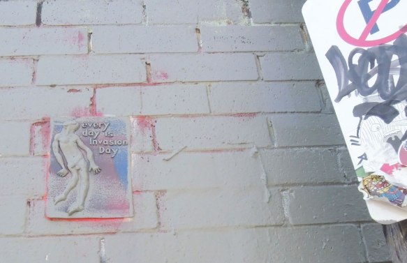 small relief sculpture graffiti of a naked man with the words 'Every day is invasion day'