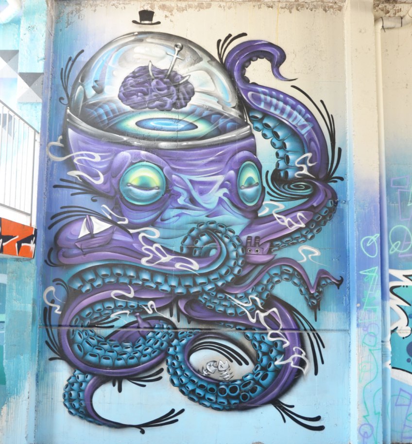 a street art painting of a blue and purple octapus