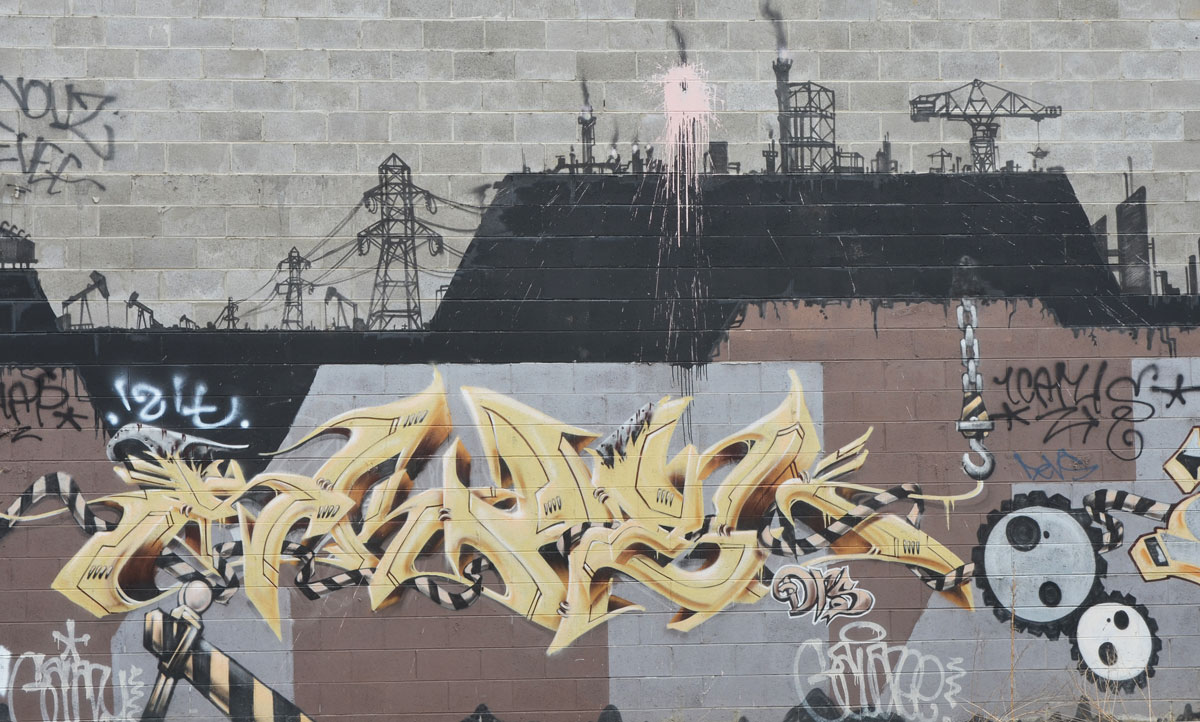 mural with symbols of industry, gears, power line, smoke stacks, 