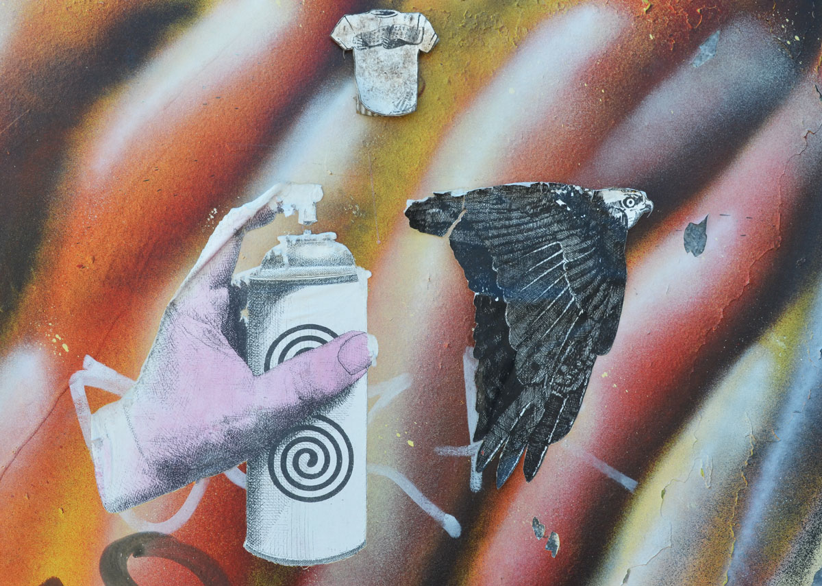 three paste ups on a wall with striped spray paint, white, black, red and gold. Small T-shirt, an eagle in flight, and a pink hand holding onto a spray paint can. It looks like the spray is aimed at the eagle. 