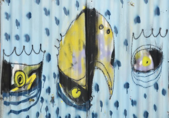 street art painting on corrogated metal fence, light blue background