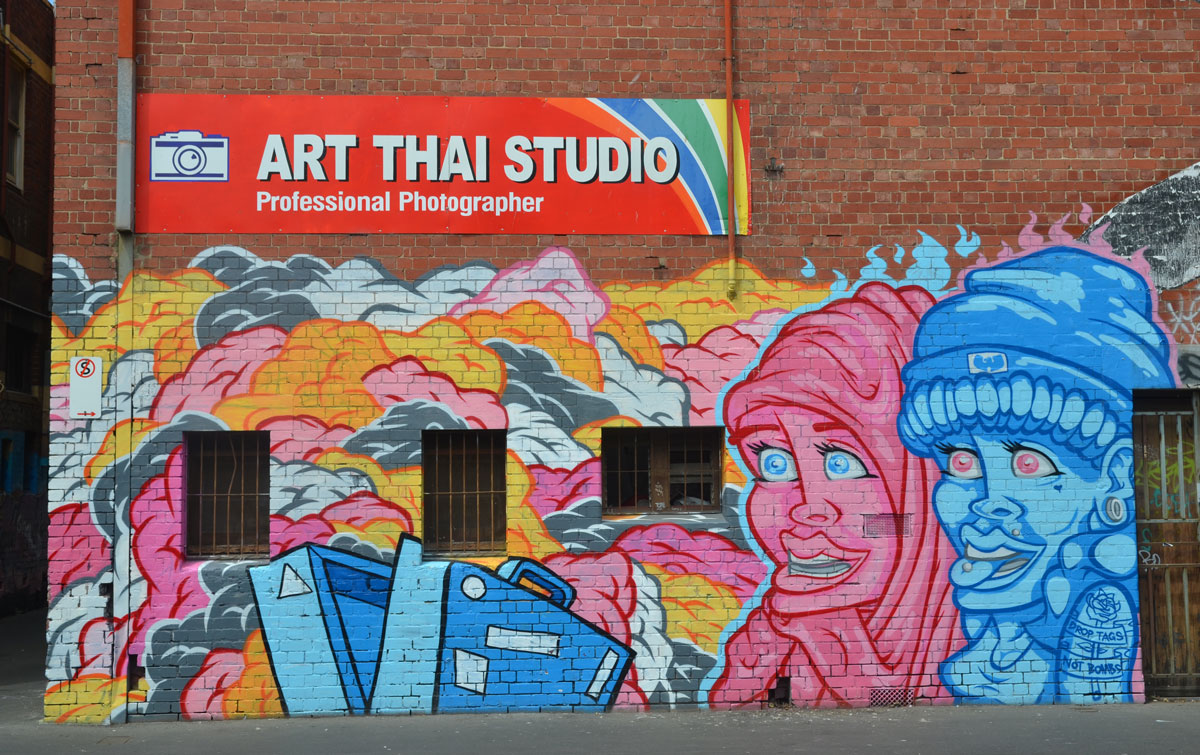 a mural featuring a pink person in head carf and a blue person 