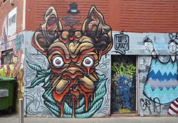 street art painting of un ugly wrinkly dog face with bulging eyes and lots of drool 