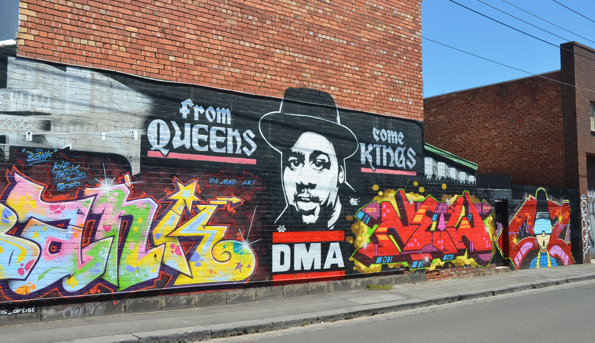 large mural in Fitzroy by kidparis, Peril, and New2, who collectively are the DMA crew, with the words From Queens come Kings, by Da Mad Art, or DMA for short 