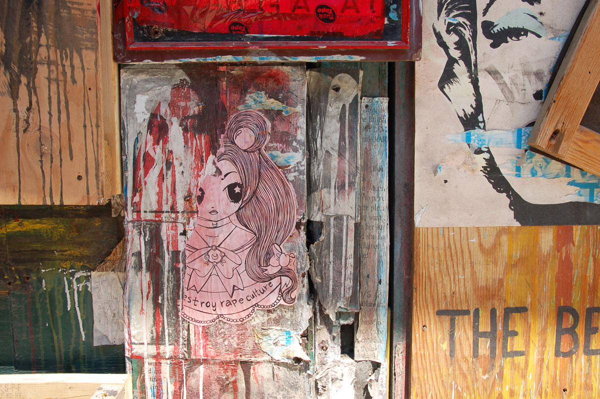 Starchild Stela character, a girl with shoulder length and slightly curly hair, paper on a wall, peeling and only part of it is still visible, painted pink,