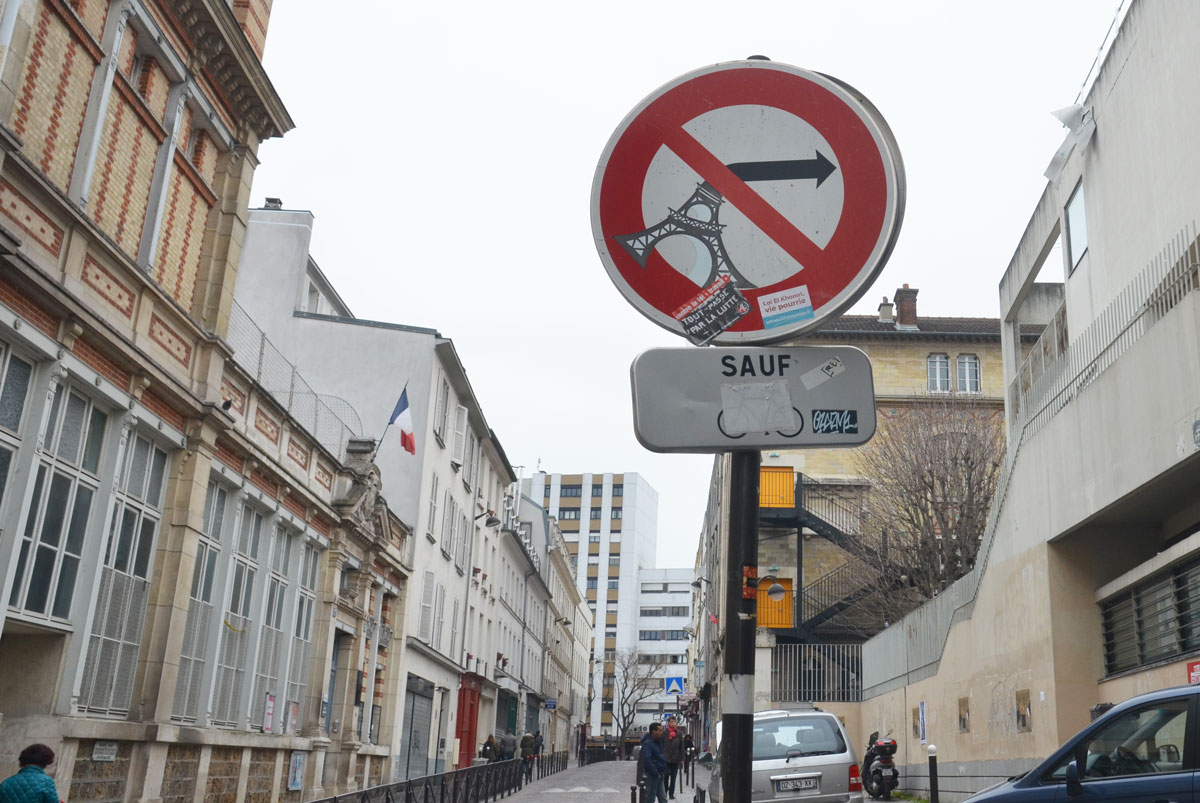 graffiti altered sign, no left turn arrow turned into the eiffel tower