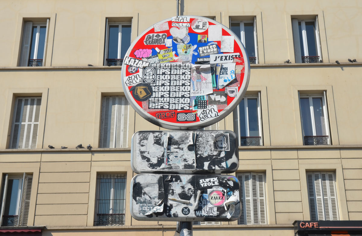 graffiti altered no entry sign, red circle with a white horizontal bar - added stickers that totally cover the sign 