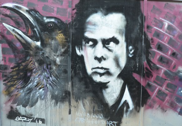 Man's face and the head of a blackbird, street art painting by Gary Alford 