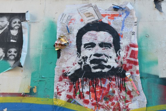 street art picture of Richard Nixon's head, with red paint splattered below. 