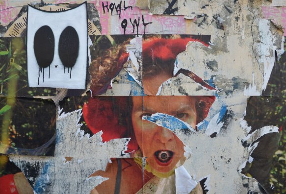 street art, collage woman's face with an eyeball in her mouth, scrawled letters of Howl Owl and a white rectangle with two black ovals, 