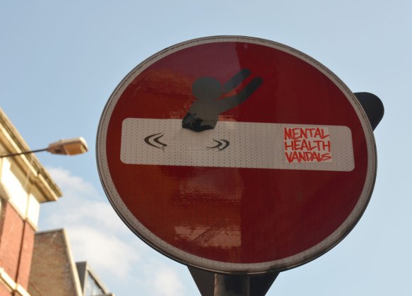 altered red and white no entry street sign 