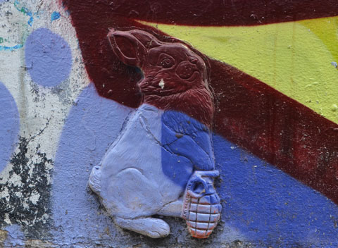 3 dimensional, (3D) bunny rabbit holding a hand grenade, graffiti on a wall 