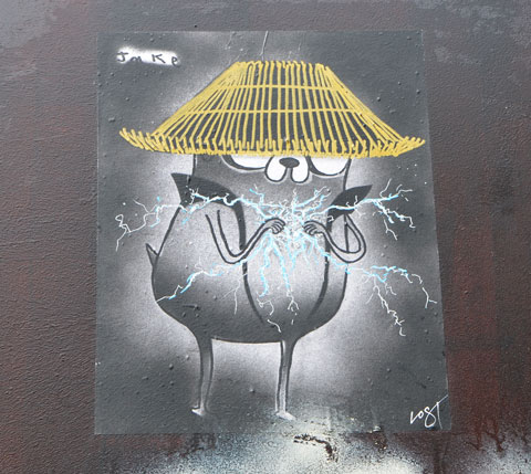 a little creature by Jake Vogt, hat on its head, hands in front almost touching with sparks and lightning being created