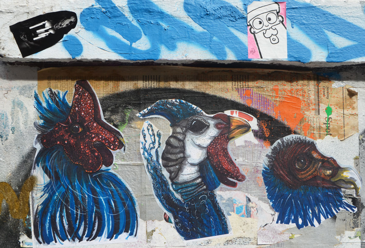 paste ups, three birds heads in blue, dark maroon and white, 