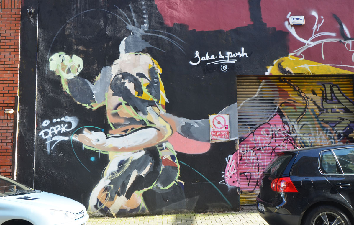 part of a mural. what looks like headless man running or walking,