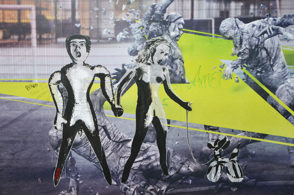 street art paste up of two people, man and woman, that look like inflatable dolls. The woman is holding the leash of a balloon dog. 