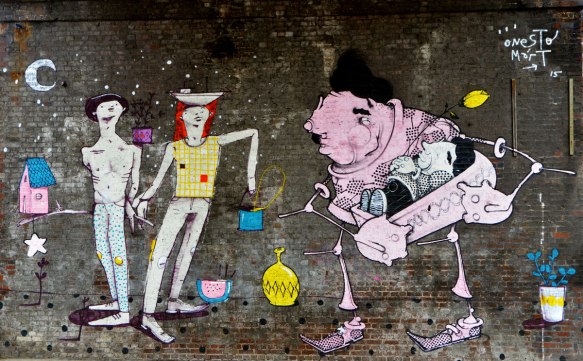 street art piece of two people and a large pink human like creature 