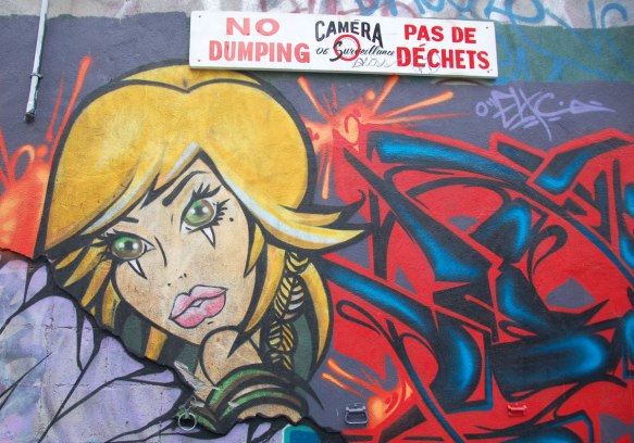 cartoon character like woman with yellow hair and a red and bllue suit 