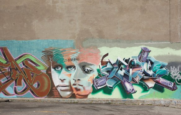 two faces are part of a larger mural