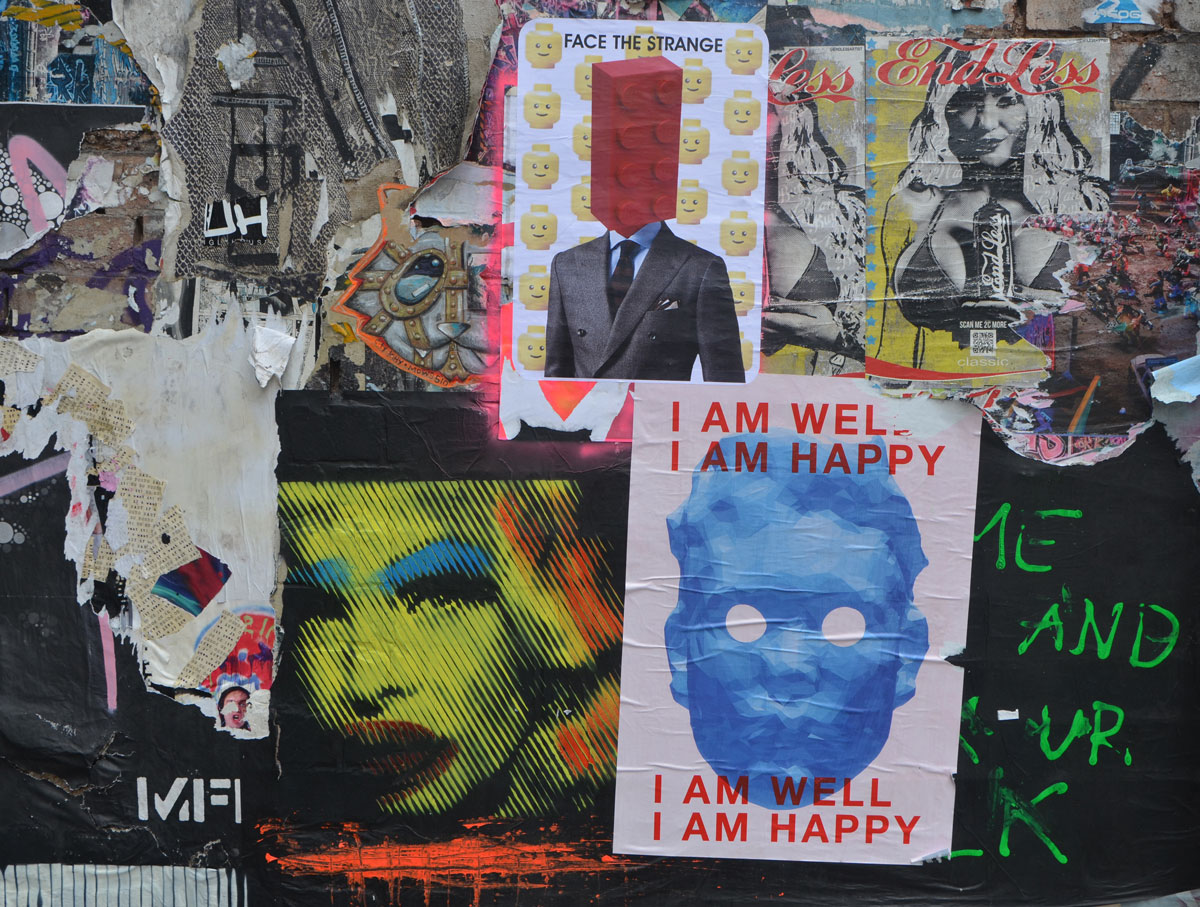 pasteup on a wall, collage of overlapping layers of pictures, jumbled up together, 