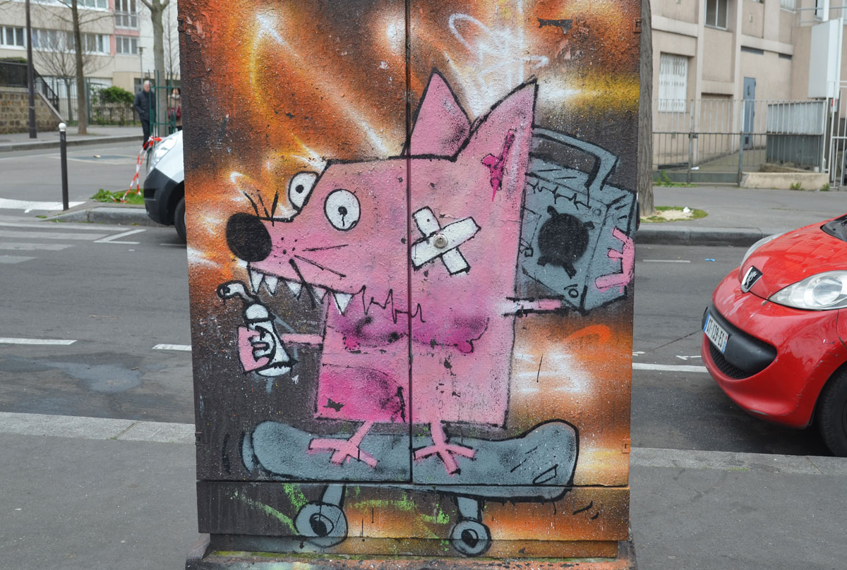 on a metal box on the sidewalk pavement beside a street, a pink squarish creature with a band aid on its cheek rides on a skateboard while holding a ghetto blaster near its ear, a spray paint can in its other hand