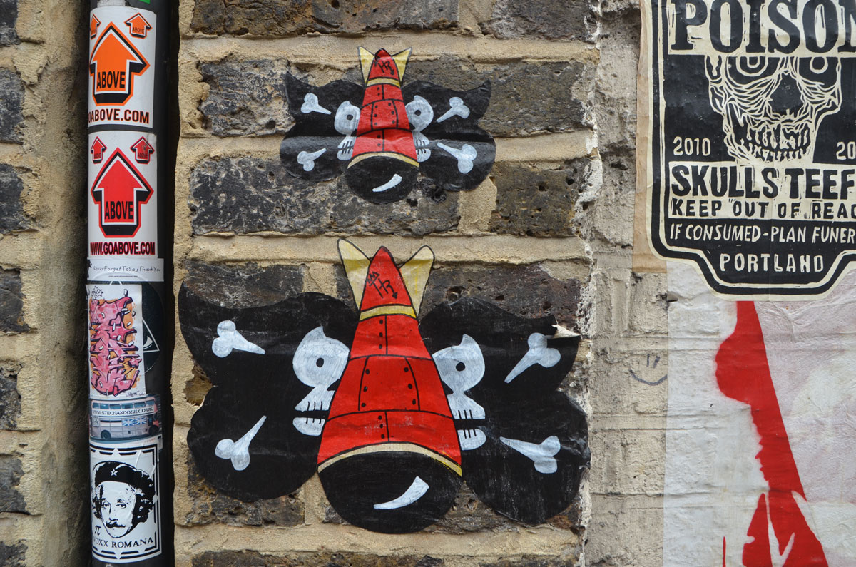 street art, red bombs with black skull and crossbones wings, 
