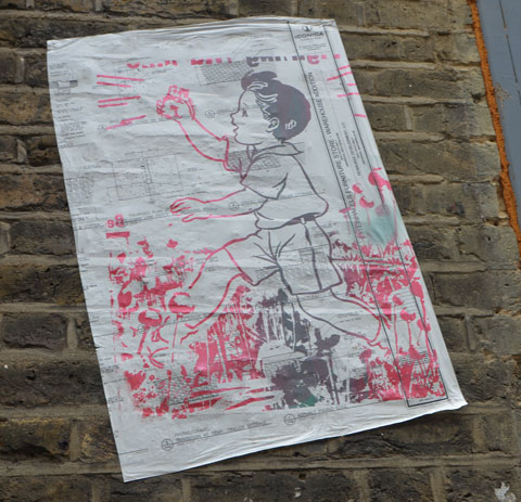 graffiti and street art on fashion street in shoreditch east london, paper paste up of a drawing