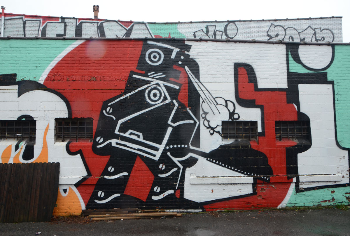 picture of a black robot figure shovelling coal 