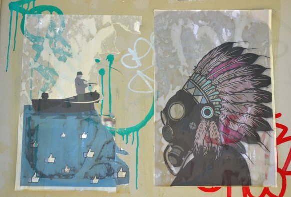 graffiti street art on a white wall - two posters, on the right an Indian in native head dress in profile and on the left, a small boat on a big wave