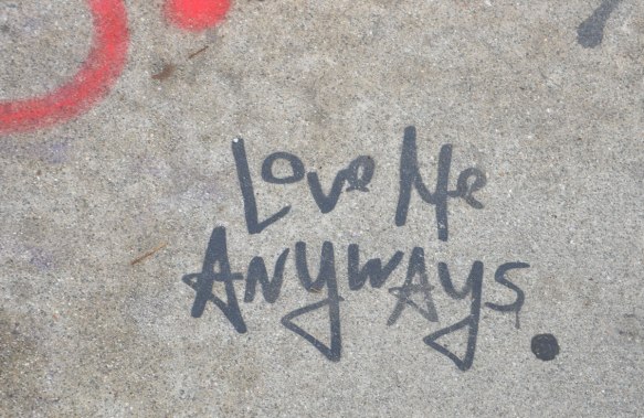 words written in black that say love me anyways. 