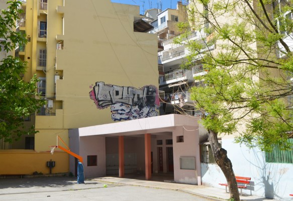 street art in Thessaloniki Greece - a throw up tag above the entrance to a school 