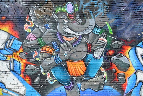 an elephant with 4 arms and two legs, bare feet, spray paint cans in its hands,
