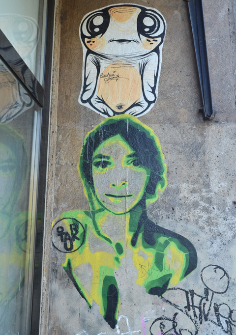 two pasteups, a woman in green and yellow and a creature by creaturi dragute 