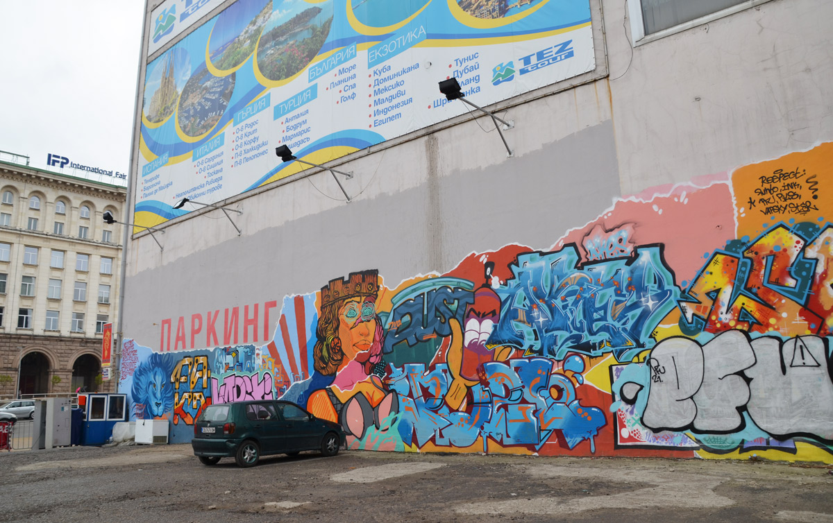 long mural on a wall, Soifa, about Sofia, lion nead and head of Sofia looking regal 