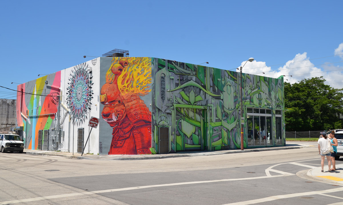 a building on a corner with murals on all sides