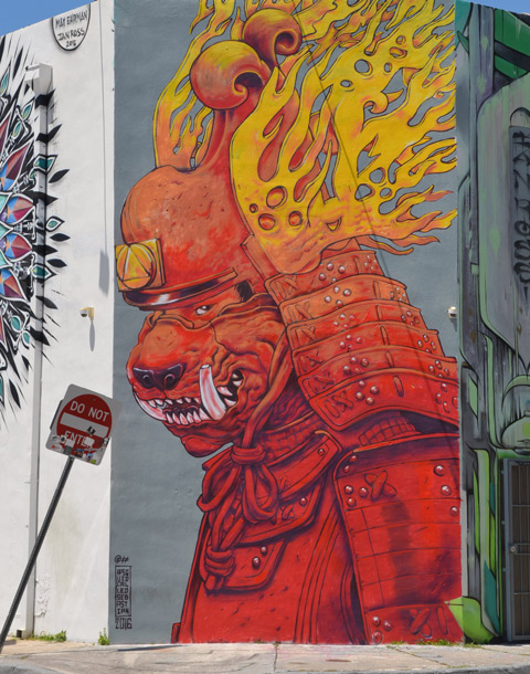 a mural by a squid called sebastien, flaming helmet on his head, dog like face, red robes 