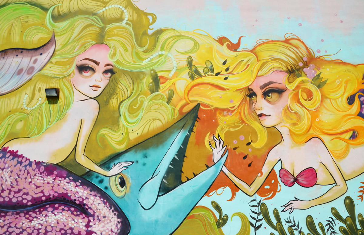 two mermaids with yellow hair in a mural by tati in downtown hollywood florida, tatunga, mermaids are with a large blue fish
