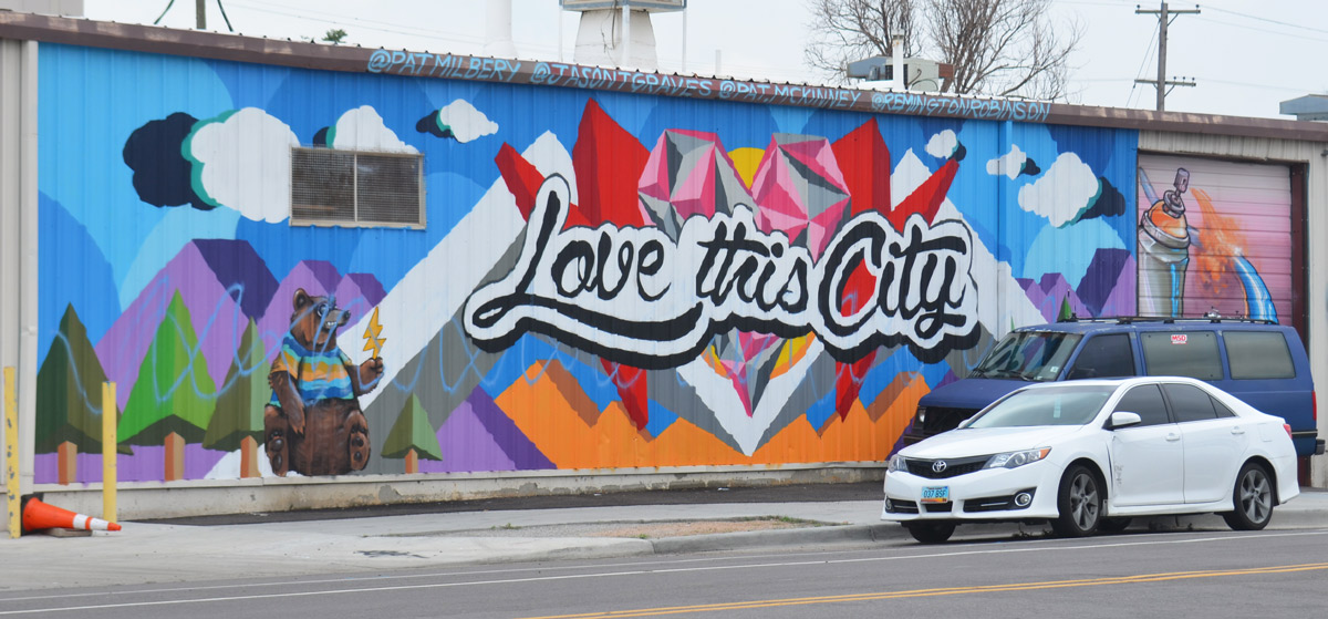horizontal mural in Denver with cursive writing that says Love this city. 