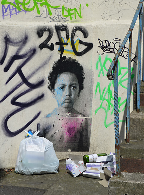 black and white photo of a cjild with curly hair and topless