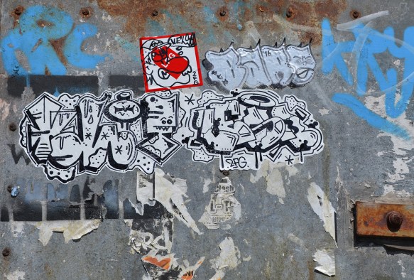 graffiti text pasteup in black writng on white paper