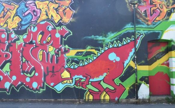 street art mural, animals, red dinosaur, with some text graffiti too 